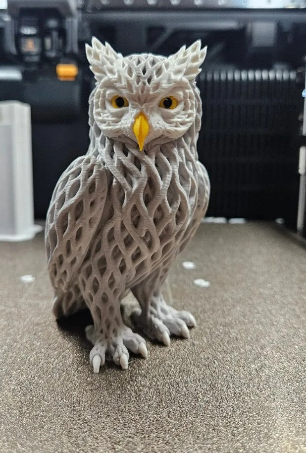Multi-color 3D printed Voronoi owl sculpture with golden eyes and geometric lattice body