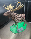 3D printed voronoi moose sculpture with green base and cream antlers